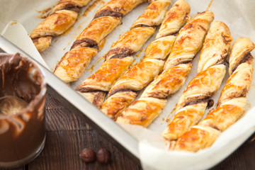 homemade cakes - puff pastry with chocolate paste. twisted cakes