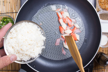 Chef put cooking rice to pan