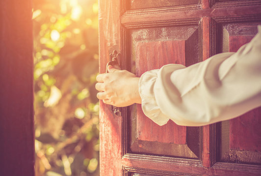 Women hand open door knob or opening the door.