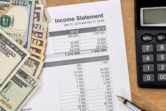 Save money concept - doc income statement with pen, calculator and money.
