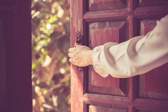 Women hand open door knob or opening the door.