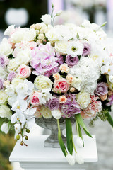 Grey Greek vase with large bouquet of white and violet roses