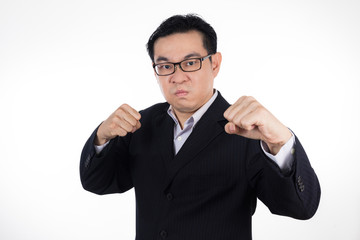 Angry Asian Chinese man wearing suit and holding both fist