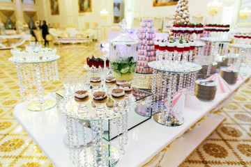 Glasses with Tiramisu stand on tall vase on long candy bar