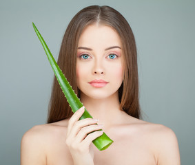 Spa Model Woman with Cute Face, Fresh Skin and Green Aloe Leaf