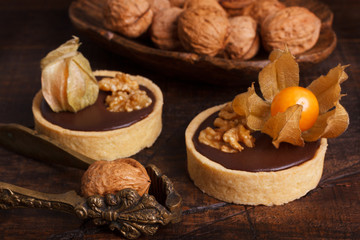 Chocolate tarts with walnut and  physalis