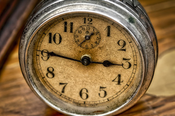 Grungy close up photograph of an antique alarm clock