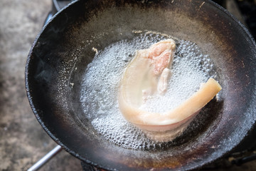 Fried pork in a frying pan