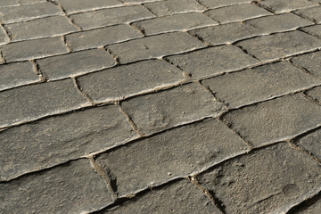 Gray stamped concrete pavement outdoor, mimics cobblestones pattern, decorative appearance colors and textures of paving cobble stone, perspective flooring exterior