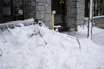 Bicycle covered with snow. Winter traffic backup accident