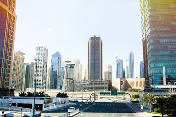 Fototapeta na wymiar Cold blue buildings of skyscrapers on streets of Dubai