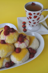 Nicely served Central European dessert of sweet steamed dumplings (an alternative version of Austrian Germknoedel) with hot fruit sauce on a colorful background

