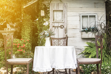 White table and chairs in beautiful garden.plublic loction