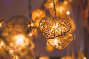 Fototapeta na wymiar Orange Lamp in Bamboo baskets in the heart shape for Valentine's Day Background Concept