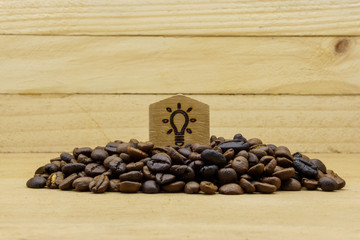 coffee bean and lamp icon on wooden background