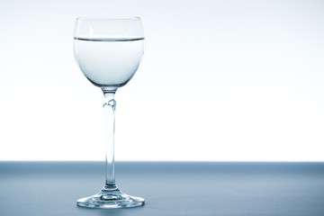 Mineral water in tulip glass close up.