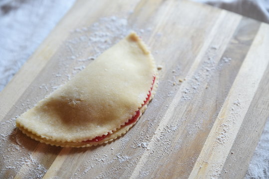 Homemade sweet pastry case on wooden board
