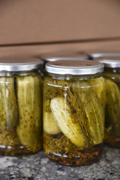 Whole dill pickled gherkins in jars