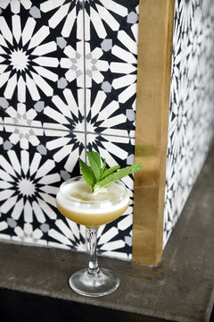 Drink in cocktail glass garnished with mint leaves