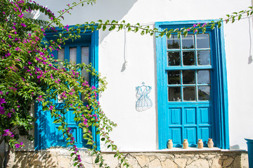 Fototapeta na wymiar Blue doors on the white wall background, Greece, Rhodes.