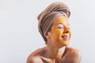 Young woman with an egg mask on her face