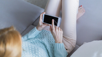 The smartphone in the hands of a young woman