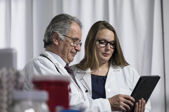 Medical Team Looking At An Ipad/tablet