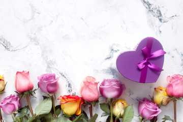 Purple and yellow roses, box present on white background