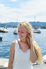 Happy young woman in dress on the lake in Zurich, Switzerland