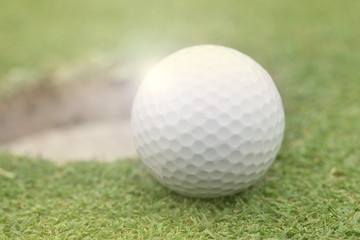 golf ball on lip of cup