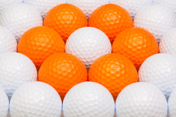 White and orange golf balls in the box