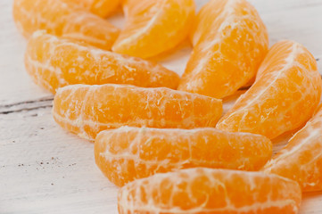 Tangerine slices on a wooden background, fruit.