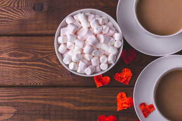Top view with copy space of two cups of cocoa or coffee with milk, marshmallows 