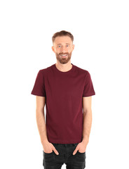 Fototapeta premium Young handsome man in claret red T-shirt isolated on white