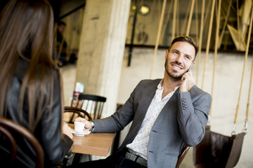 Young couple sitting in a cafe and talking