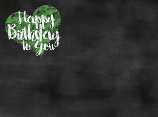 words happy birthday to you written on blackboard with green heart, copy space