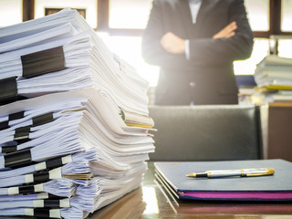 Close up of business documents stack on businessman background