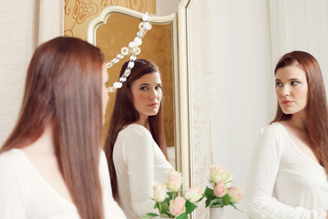 Naklejka premium Woman looking into mirror