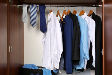 Many man's clothes in wardrobe, closeup