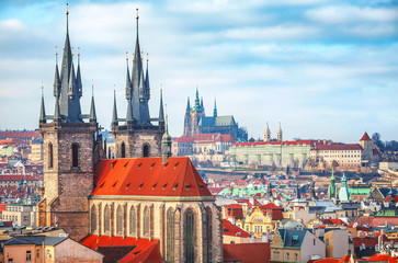 Fototapeta na wymiar High spires towers of Tyn church in Prague city