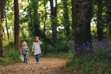 Fototapeta premium Two girls walking through a forest