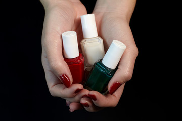 Polish bottles in woman hands.