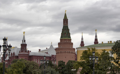 View of Nikolskaya Tower and Red square area from Alexandrovsky Garden in Moscow. Landmark gated defense tower built in 1492, known for the small star atop its steeple. It's cloudy autumn day.