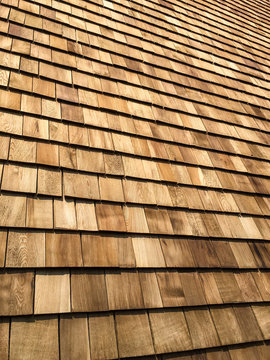 A background of newly installed cedar shingles.