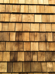 A background of newly installed cedar shingles.