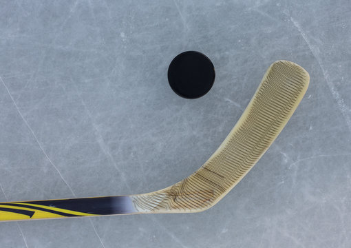 Hockey Stick And Puck On The Ice