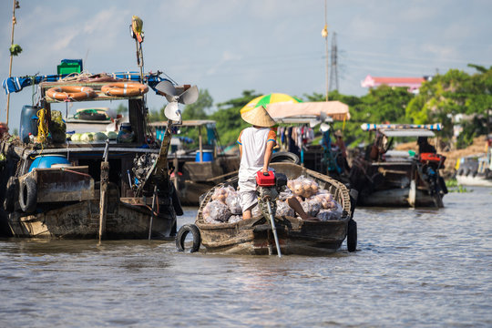 Busy morning in Mekong river delta, Vietnam. Wood boat selling fruits and vegetables on floating market in the Can Tho, Mekong Delta.