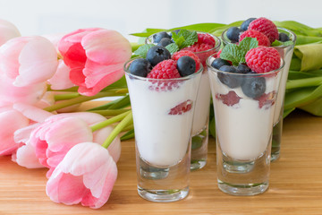 Glass with yogurt and berries close up.