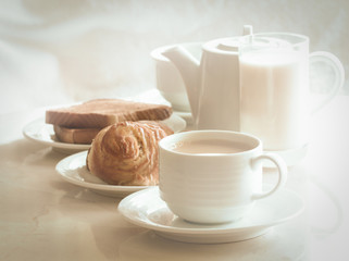coffee and cinnamon roll, toast, milk,  for breakfast.