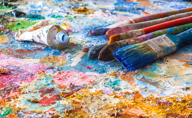 oil paints and paint brushes on a palette
